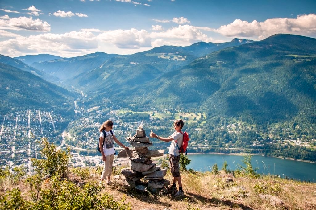 Young Hikers Building Cairns